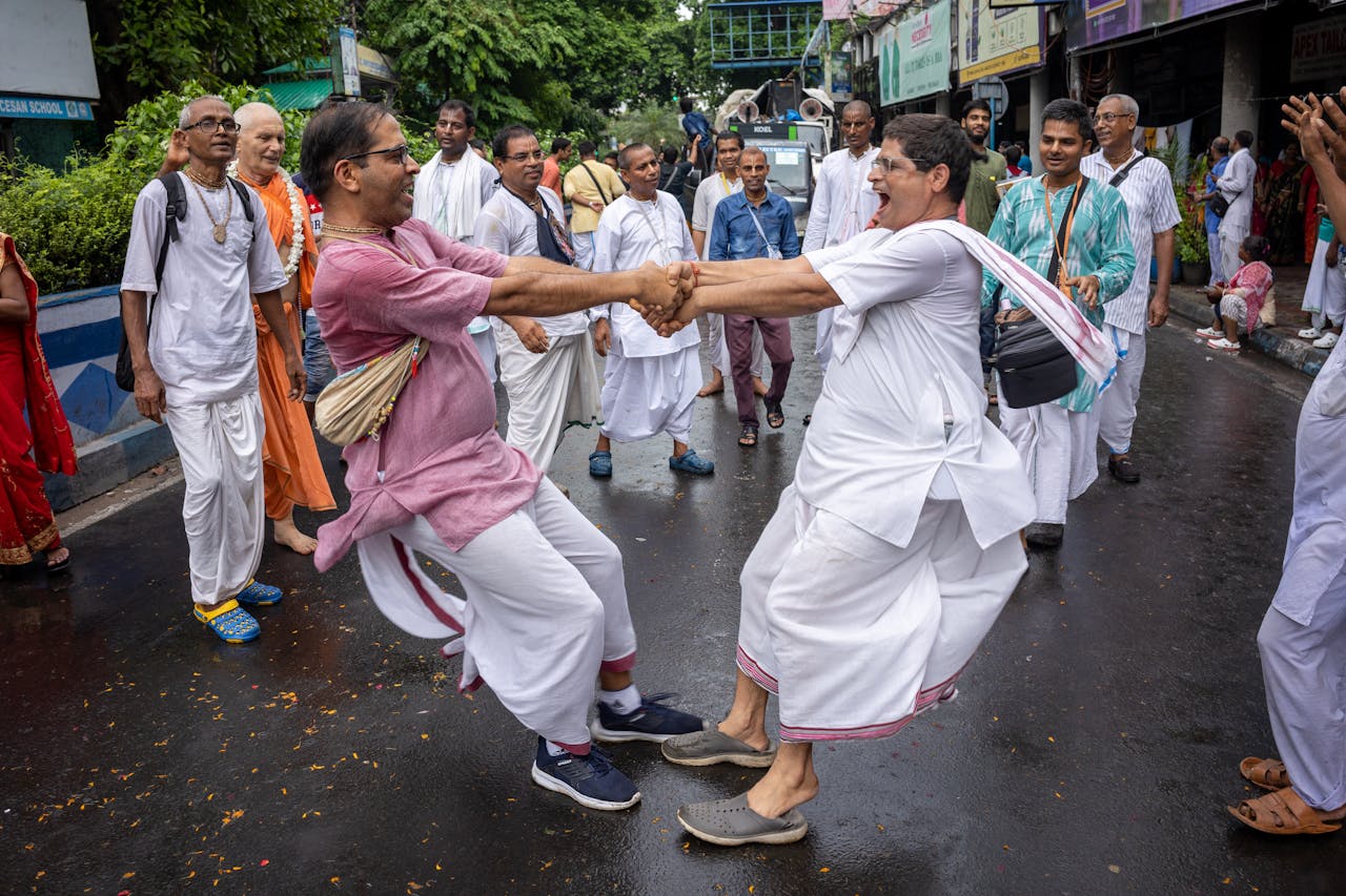 Group of people enjoying a traditional dance on a vibrant street.